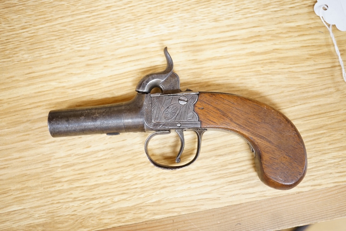 A boxlock percussion pocket pistol with turn off barrel, Birmingham proofs, trophy engraved frame, and slab walnut butt